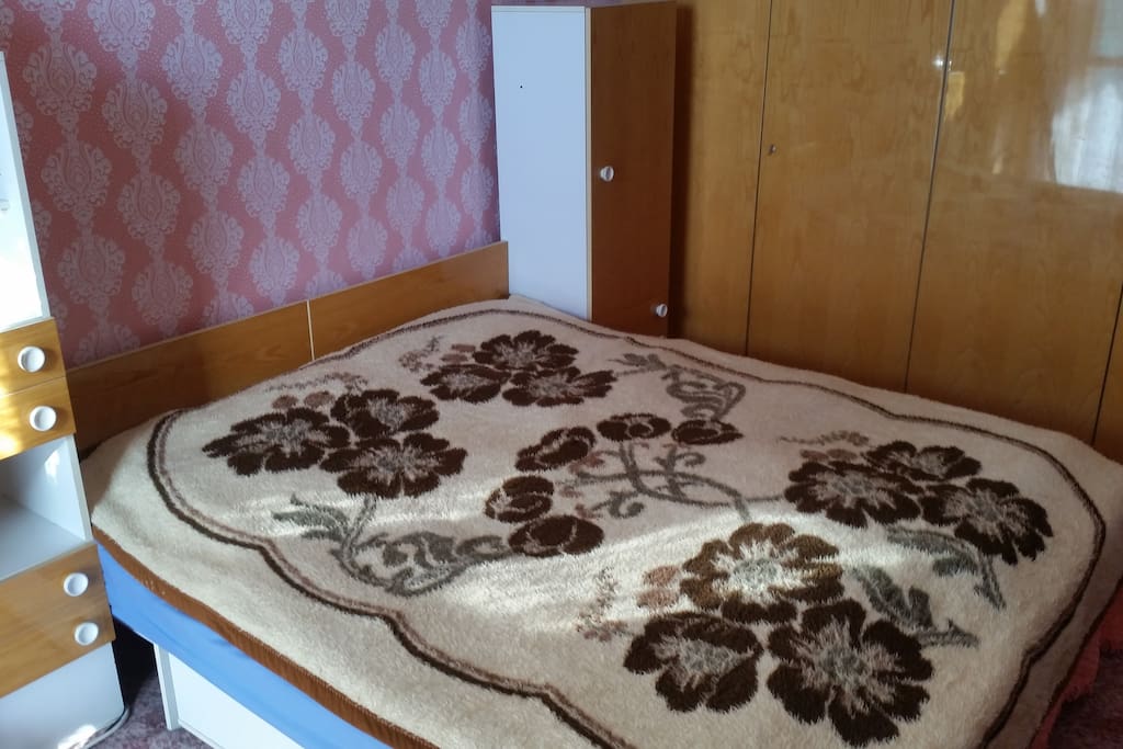 Master bedroom with double bed and balcony.