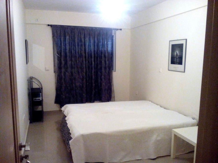 A two room studio on the underground floor sunny and bright. One space has couches and 2 single beds with tv and bathroom.The second space has one double bed.