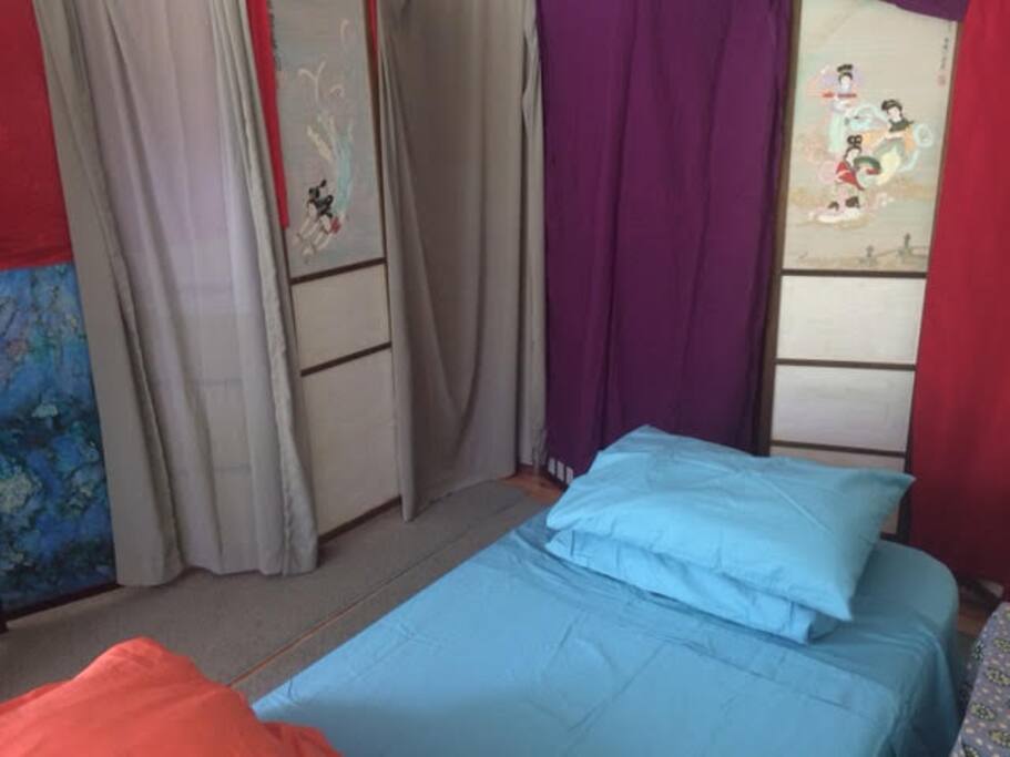 Single thick Memory Foam Mattress closed off with Shoji Screens - view looks out at waterfall, creek, trees and greenery.