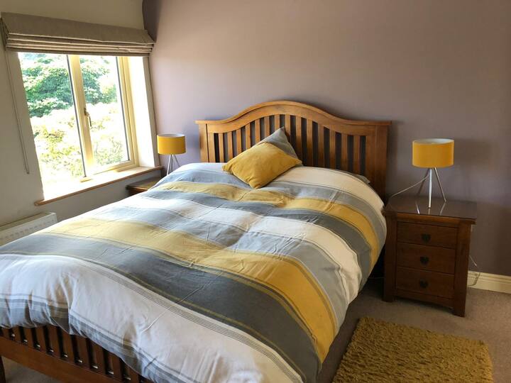 Main bedroom with king size bed. Ensuite bathroom with toilet and shower. 