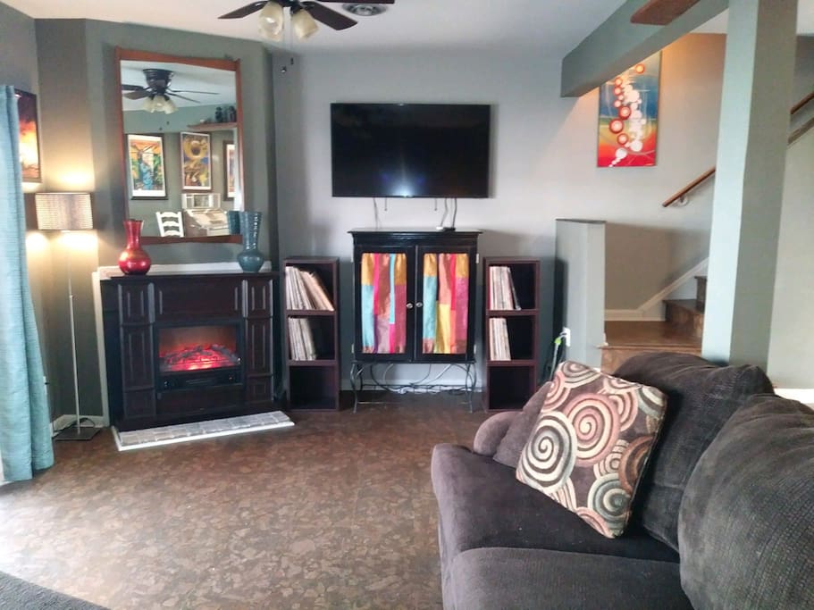 Spacious living room with a 60” HDTV and space heating fire place overlooking the inlet out the back door.