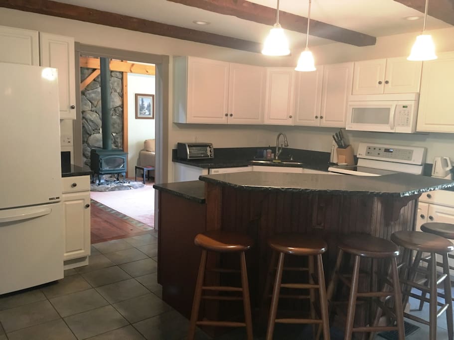 Kitchen. Counter seating for 5, table seating for 8, door to back deck and BBQ area.