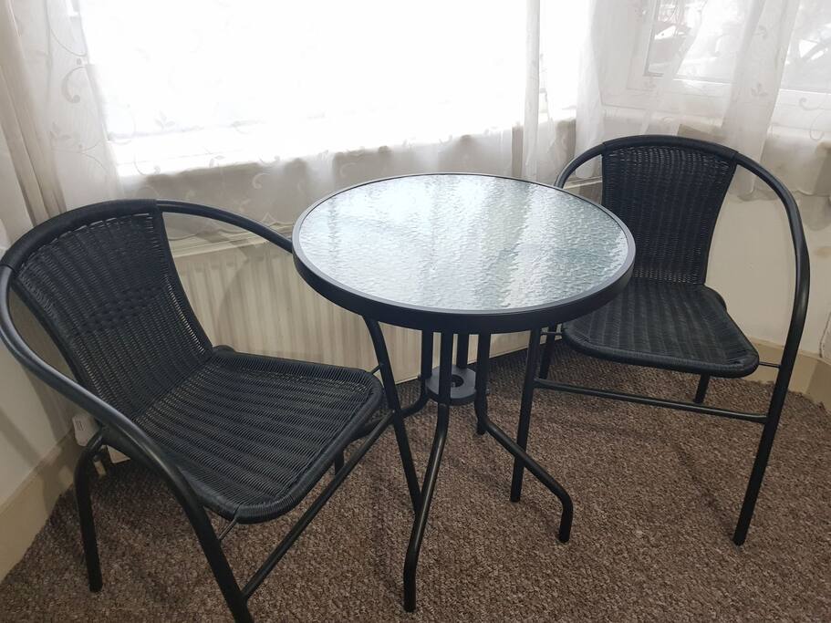 Table and chairs in room with big windows for the view