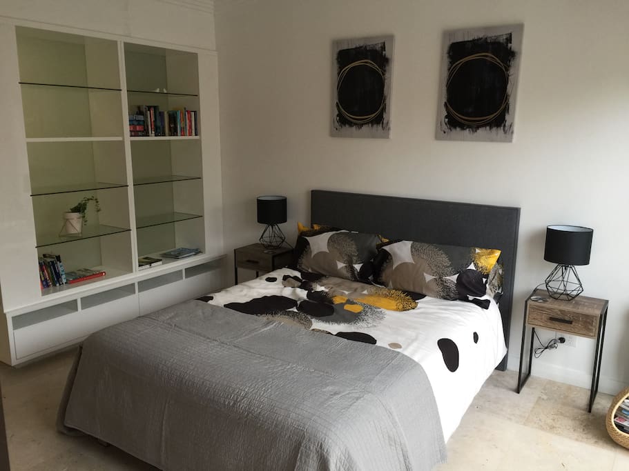 Double bed and ample storage for your stay. Dyson cool and hot air system, iron, all bedding provided. Opens to patio garden area. Through to ensuite bathroom.