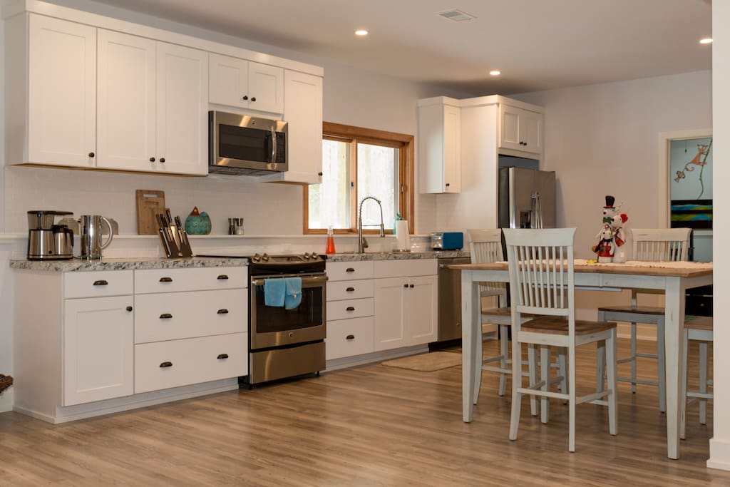 Full size kitchen with brand new SS appliances ans gas stove top with a wonderful view of the forest.