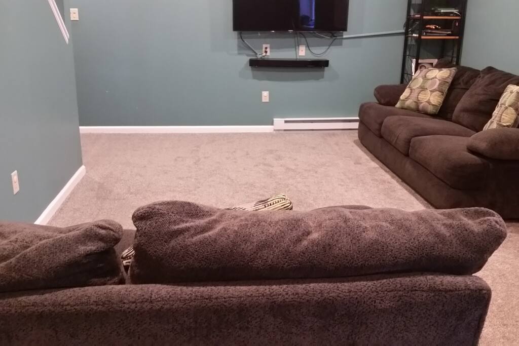 Finished basement with a couch and loveseat. Can sleep 2. 50 inch TV.