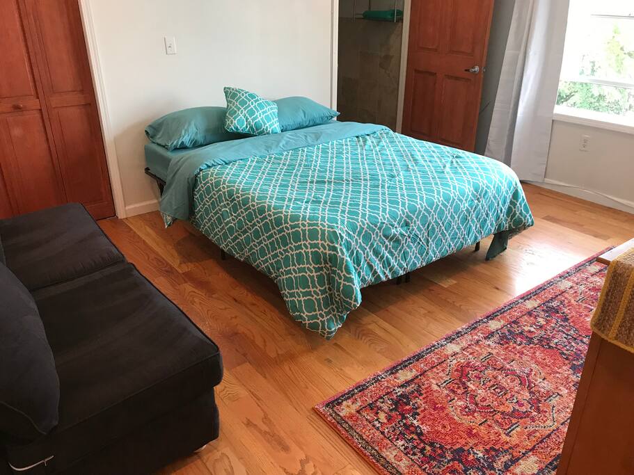 Comfortable Queen size bed with throw rugs