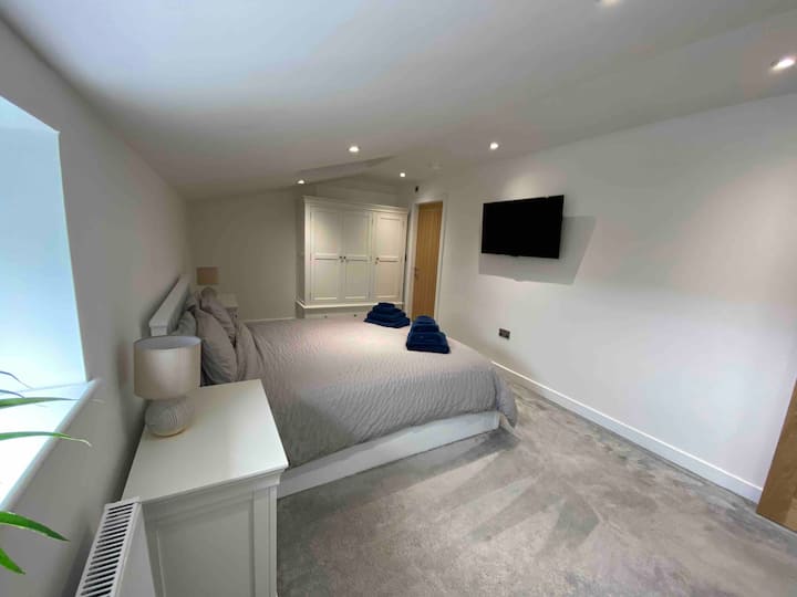 Bedroom with plenty of storage space, King size bed and tv. 