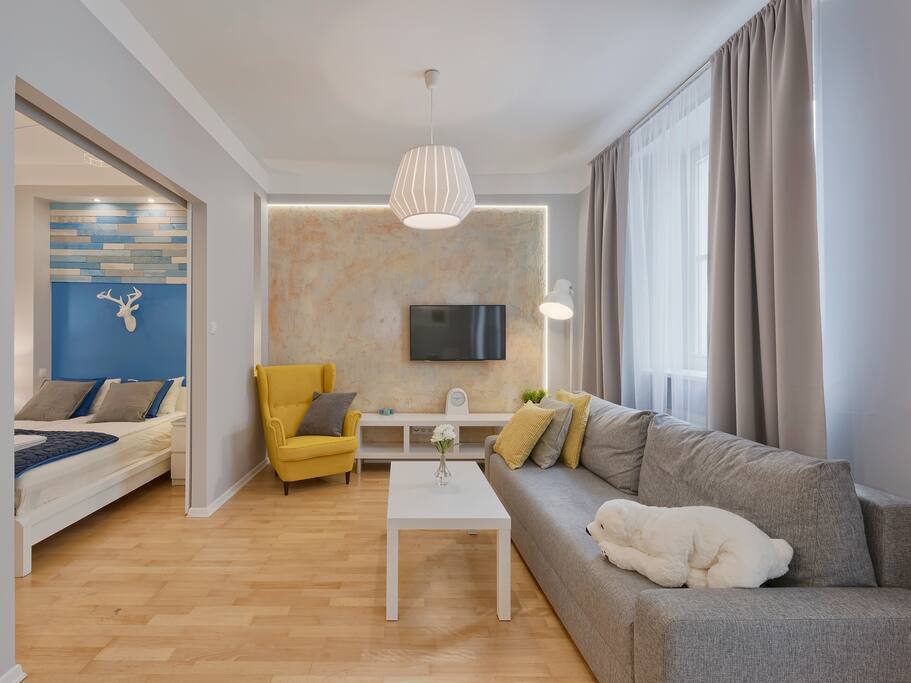 yellow bedroom with tv and armchair