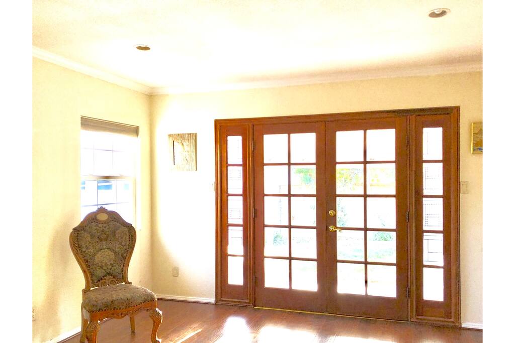 Den leads out French doors to backyard