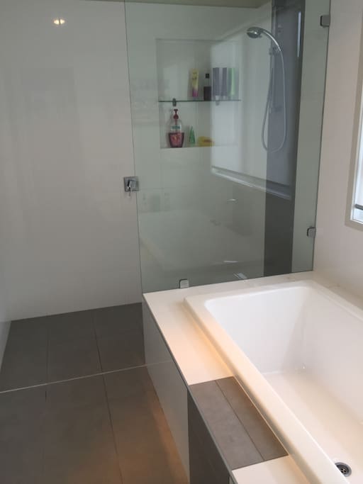 Large bathroom with bath and walk in shower.