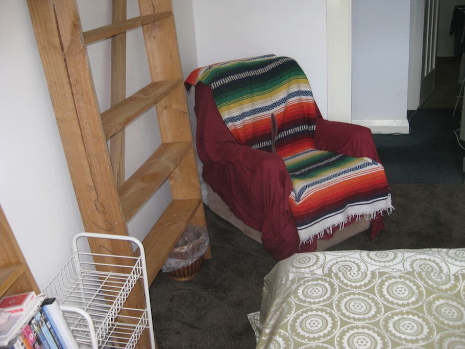 Armchair can be removed and/or replaced with a desk if desired. Shelves and coffee table can also be removed if desired.