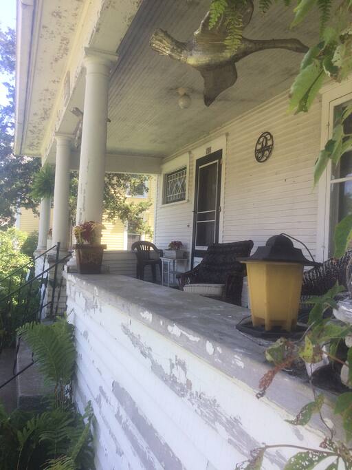 A comfortable front porch in need of some TLC.