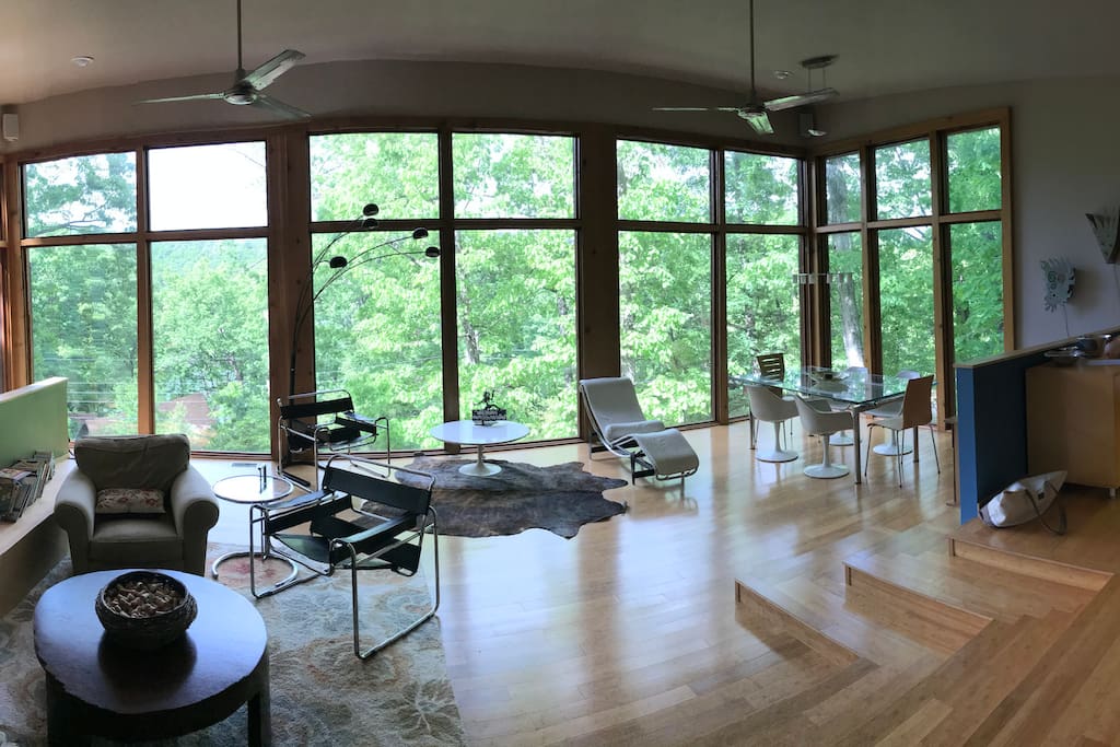 Main living space features a wrap around wall of glass. It creates a tree house feel in the summer when all the leaves are out.