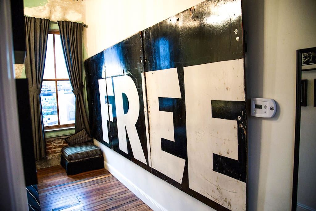 Room decor includes an eclectic mix of vintage black and white art.