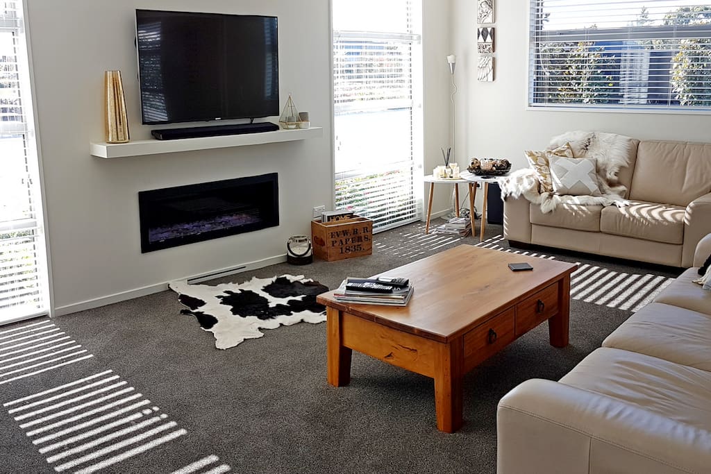 The front living and media room with a cosy gas fire perfect for winter months