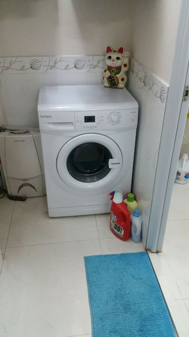 New washing machine and clothes line out the window.