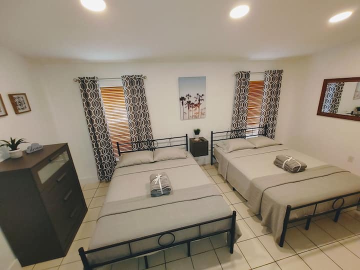 Primary bedroom with two Queen pillow-top beds with ample storage underneath the beds and in the large walk-in closet and dresser and shelves. Also Smart HDTV and more.