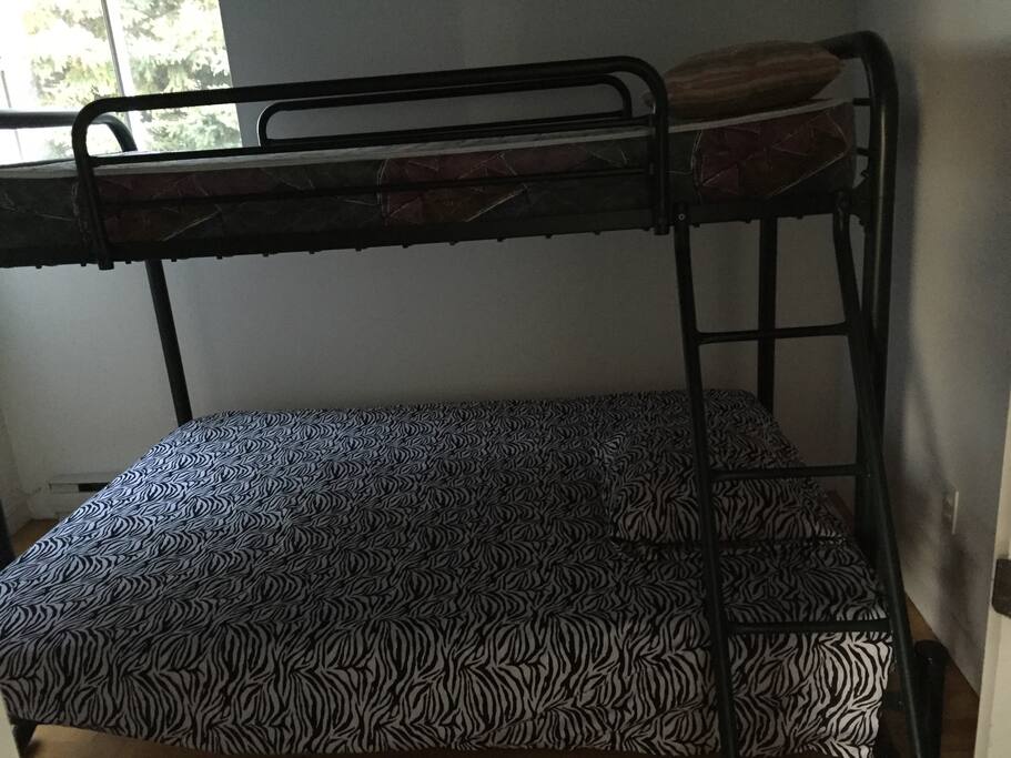 Voici une chambre avec lit superposé, double en bas et simple en haut