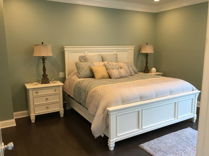 Master bedroom with king-size bed and tv located on the main level with access to the enclosed patio.  The private master bath has a spa shower as well as a soaker tub. 