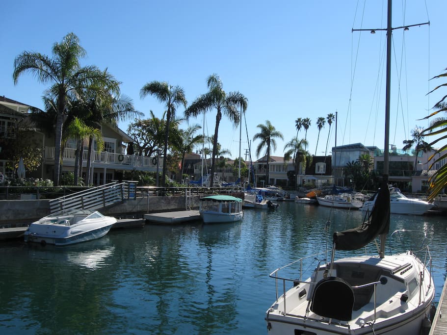 Home is ocean front ON canal! This is a ground level view from deck facing the ocean canal