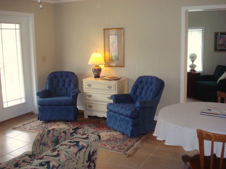 The sitting room has a sofa and four easy chairs plus a table and chairs for eating and games.
