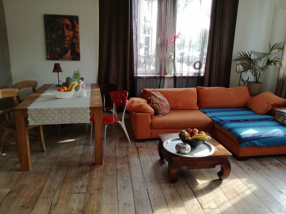 Living room with teakwood table and 4 chairs, ideal for cozy dinner gatherings.