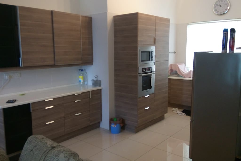 American style kitchen with Ikea cabinets and built in oven and microwave.