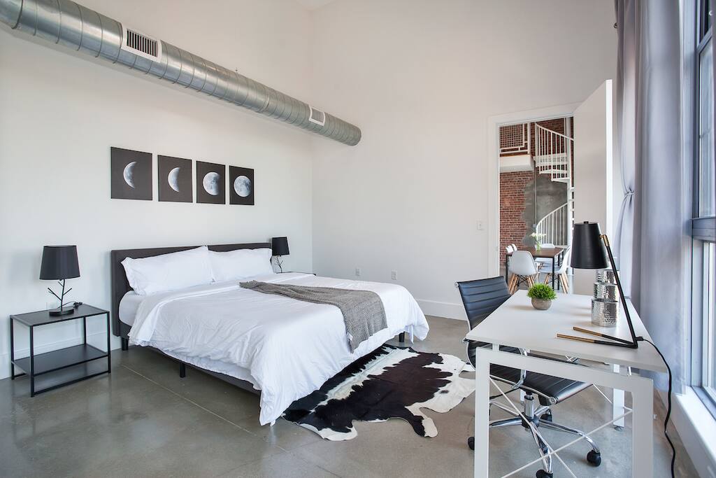 Master Bedroom with queen bed, working space, and city views