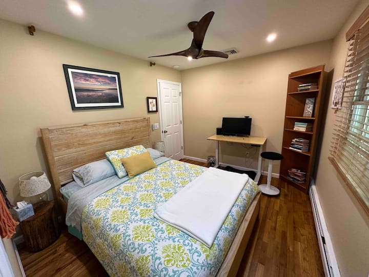 Dormitorio 3: "Seabird Nest" es acogedor con una cama tamaño queen con colchón firme,  moderno escritorio de pie con monitor de 27 pulgadas, libros para leer. Armario adjunto con plancha/ tabla de planchar y mantas adicionales, y mucho espacio para colgar o guardar tus artículos. 