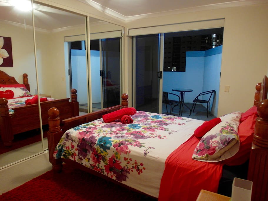Large queen size bedroom with private balcony on city view