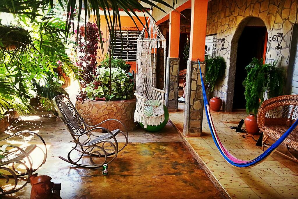 On the right are the 2 guestrooms, the blue rope is a hammock, straight ahead is the kitchen, and to the left is a private side entrance.