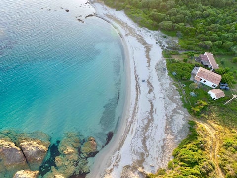 House  in a cove, on a sandy beach