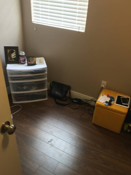 Just left of the bed.