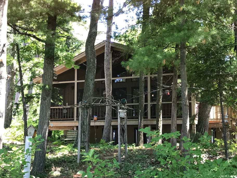 Front view of the house, which faces the bay. The screened-in deck stretches along the entire front.