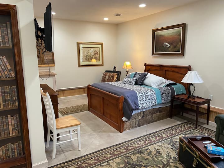 Queen size bed with back up linens in cabinets, and Tv that can pivot to bed, seating area or dining table