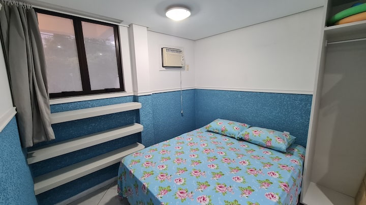 View of the demi suite, with a curtain, air-conditioning and a double bed.