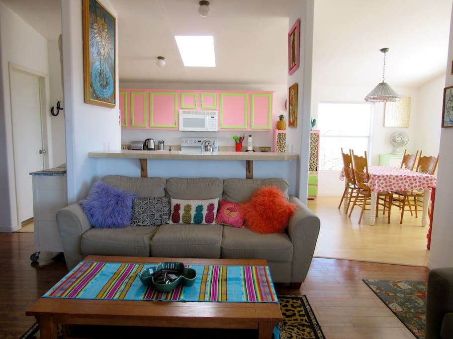 Open to the doors to a very bright and colourful open plan area with large lounge/kitchen/dining area