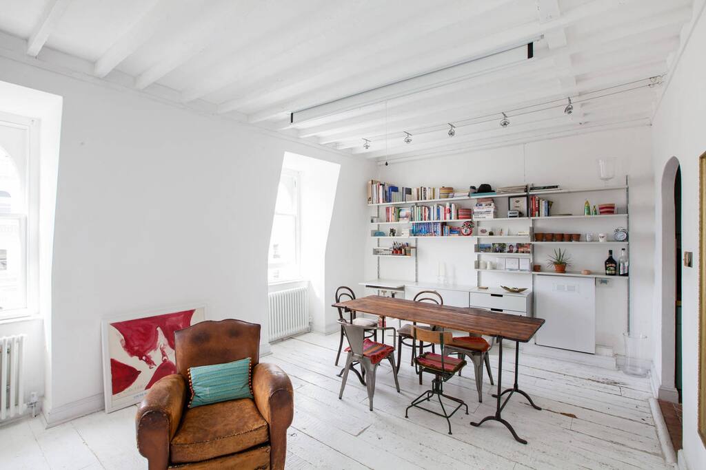 Another view of our spacious and light sitting room, with dinning area and book shelves opposite the sofa. Please note we don't have TV but we have very fast wifi for you to use and watch Netflix, Amazon Prime etc (we don't provide subscription) on your laptop.