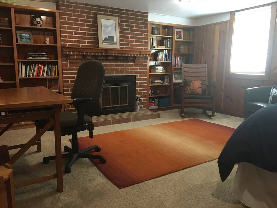 View of bedroom with queen bed, desk and sitting space.