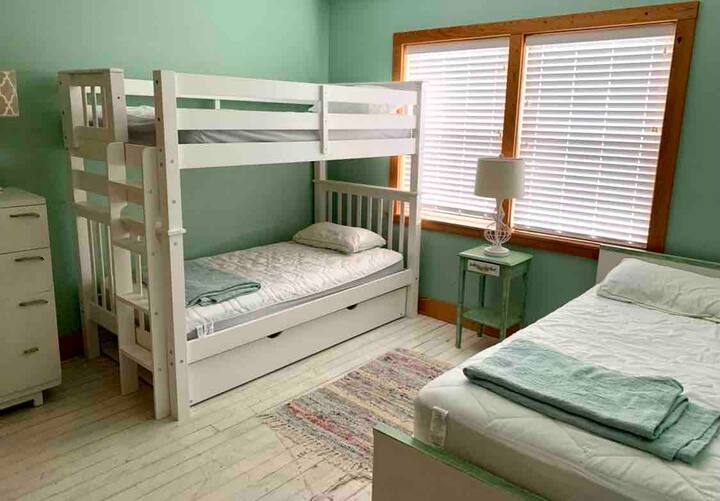 Second-floor bunkbed, bedroom has bunkbeds, as well as one single. All flooring is original heart pine from the 1940s.