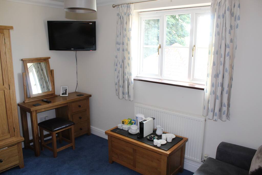 An oak dressing table with mirror and hair dryer