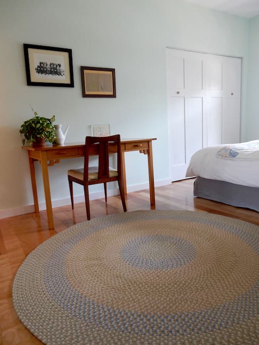 Large bright bedroom with desk and ensuite bath.