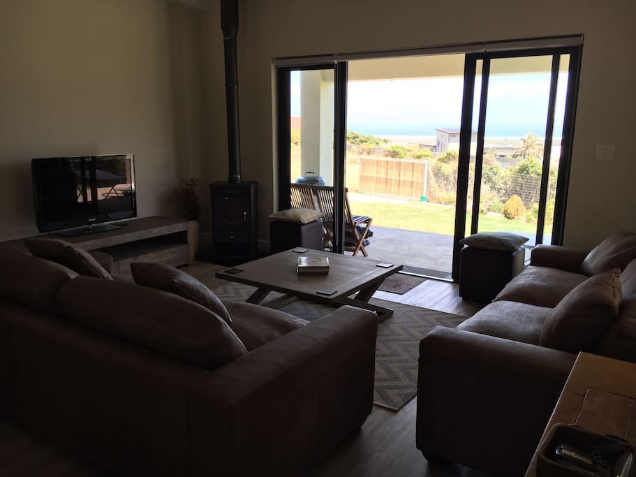 Lounge with sliding doors leading onto covered patio area