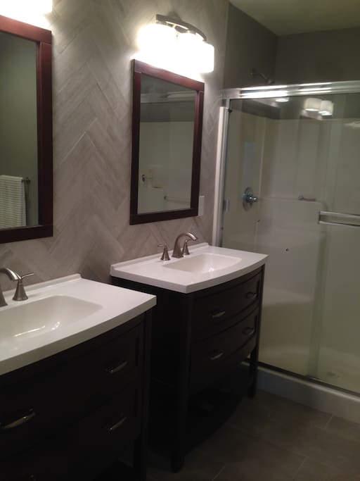 Master bathroom with dual vanities and roomy shower.