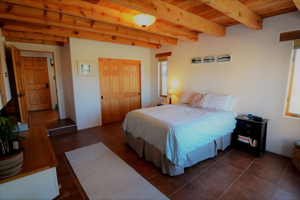 Bedroom with queen bed, closet, dresser, smartTV, private bathroom and access to washer/dryer. Wifi is available throughout the guest accommodations