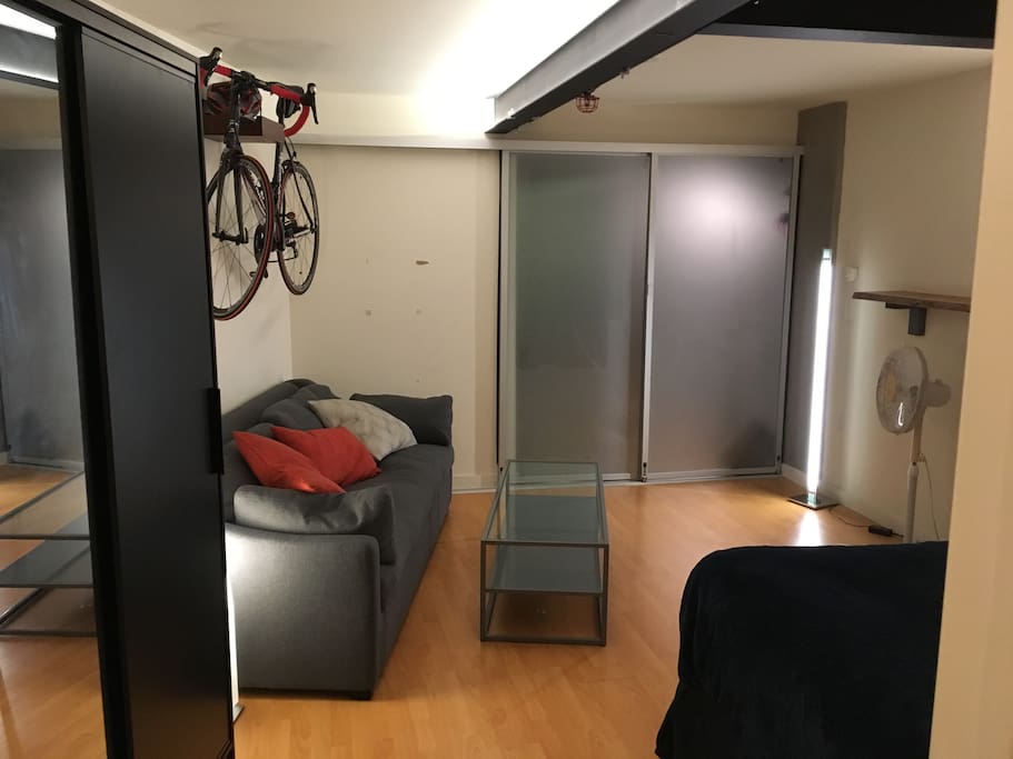Sliding doors open to the main space, letting in wonderful sunlight during the day (photo is at night).