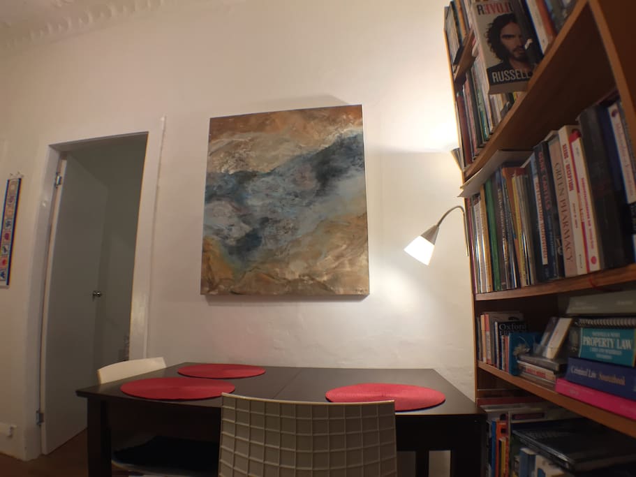 Painting 'The Lagoon' by Australian artist Warwick Baird above dining table
