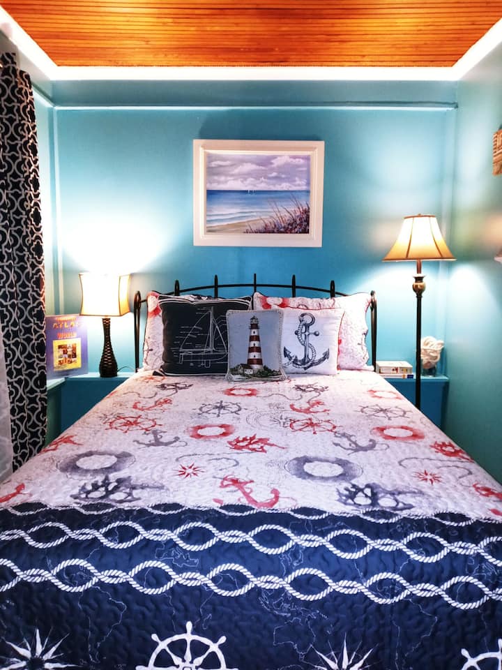 Feels like you’re in the Captain’s quarters in this cozy nautical themed bedroom.