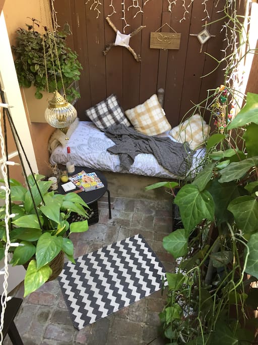 Private outdoor patio with reading nook and breakfast table.